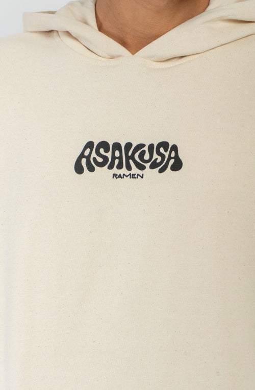 Sudadera oversize unisex de algodón orgánico color crudo con gráfico Asakusa Ramen en el pecho e ilustración de una rana en un bol de ramen en la espalda.