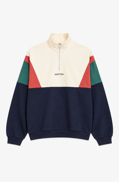 Sudadera unisex Arthur con cuello alto y media cremallera, diseño color block crudo, azul marino, verde y rojo, y logo Kaotiko en el pecho.