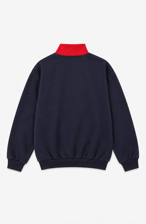 Sweat unisexe James bleu marine et rouge avec bande écrue en V, col montant zippé, poches latérales et logo Kaotiko sur la poitrine.